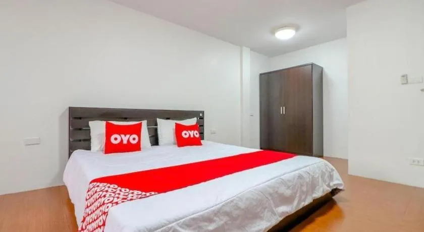 Bed in OYO 935 The Palm Apartment