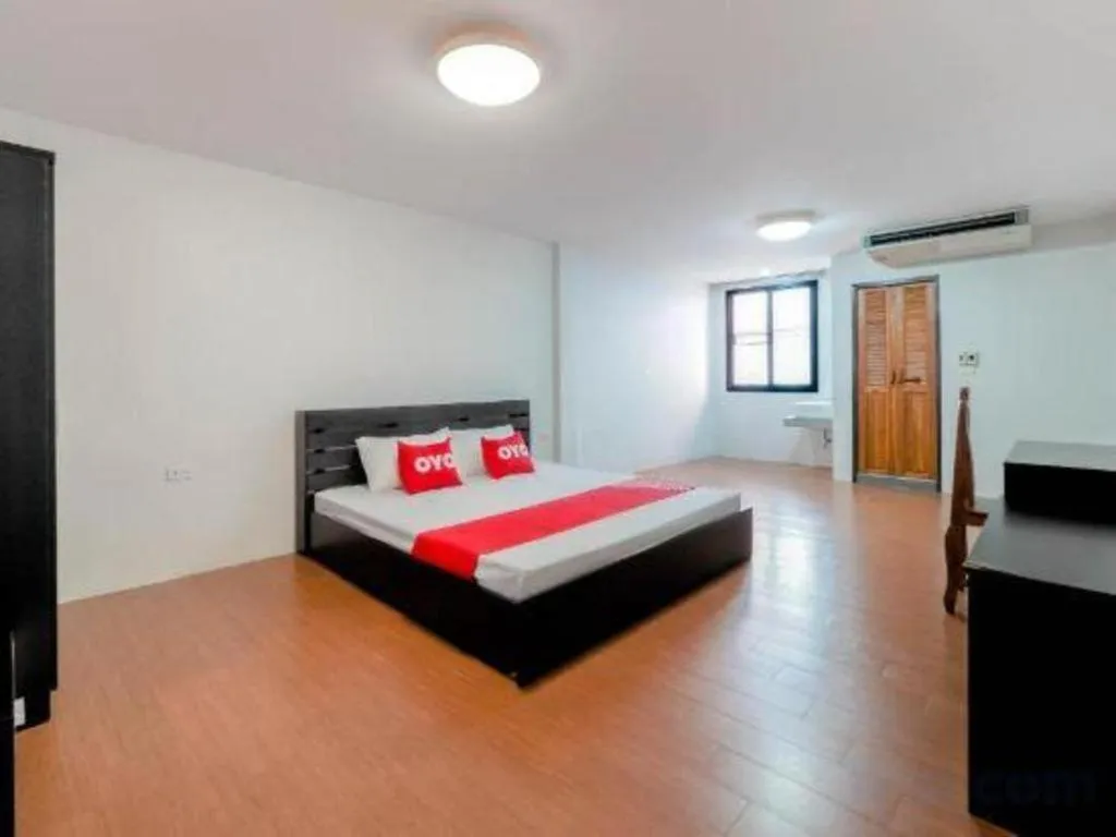 Bed in OYO 935 The Palm Apartment