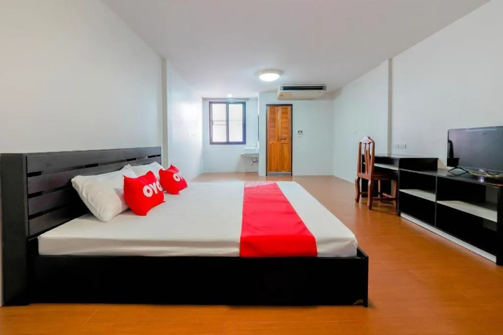 Bed in OYO 935 The Palm Apartment