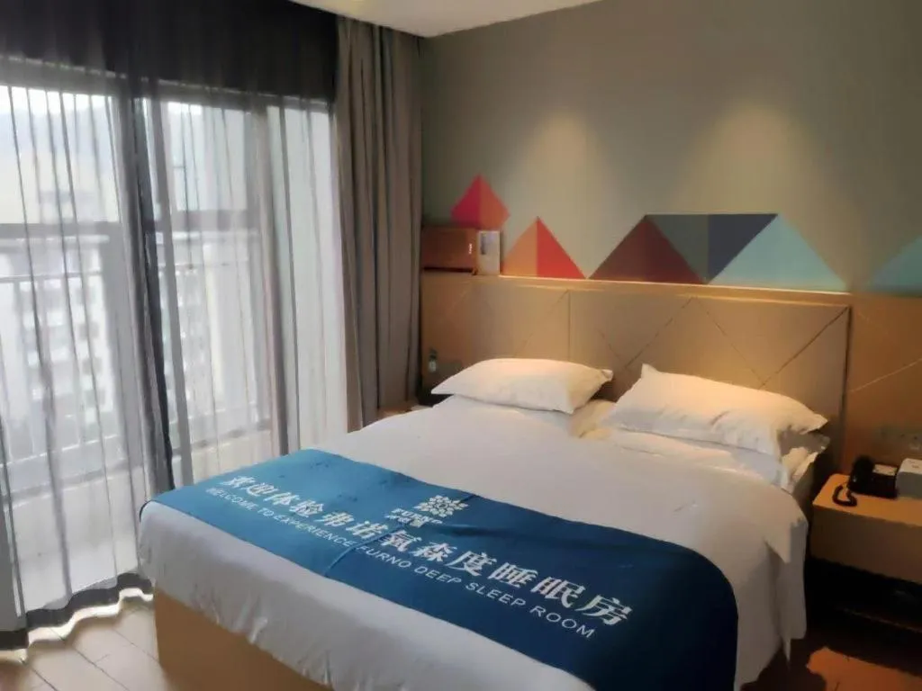 Bed in Borrman Hotel Zhaoqing Sihui Tianguangxu Jade City