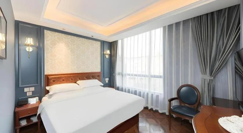 Bed in Yitingzhenshe Hotel Beijing Qianmen