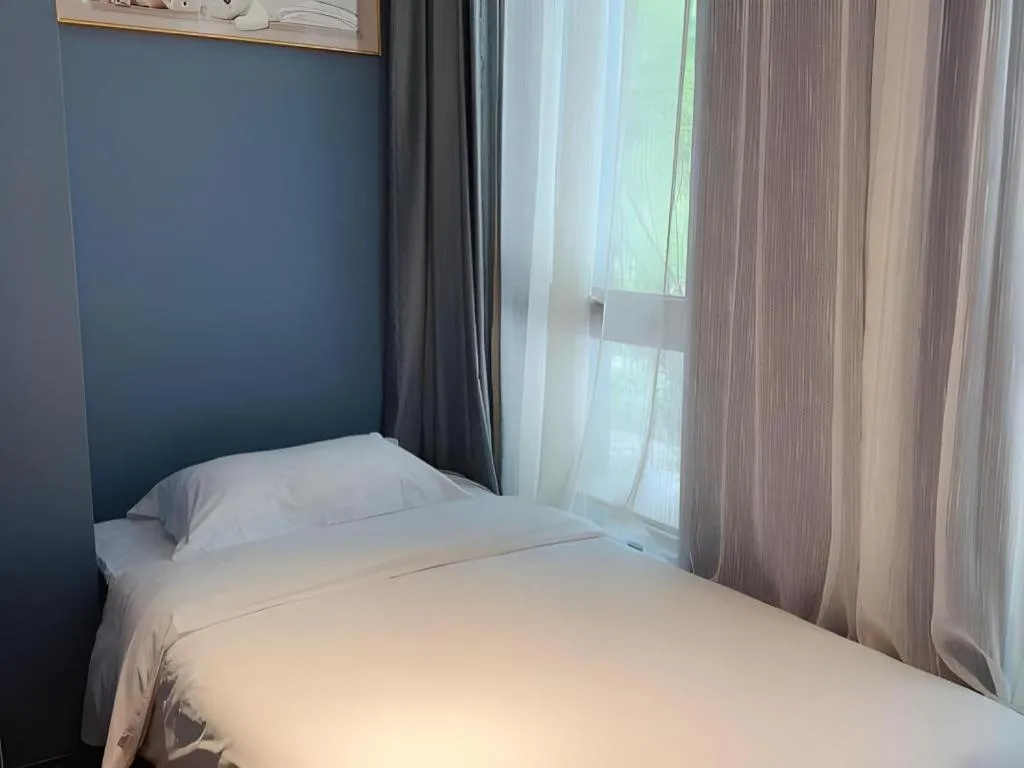 Bed in Yitingzhenshe Hotel Beijing Qianmen