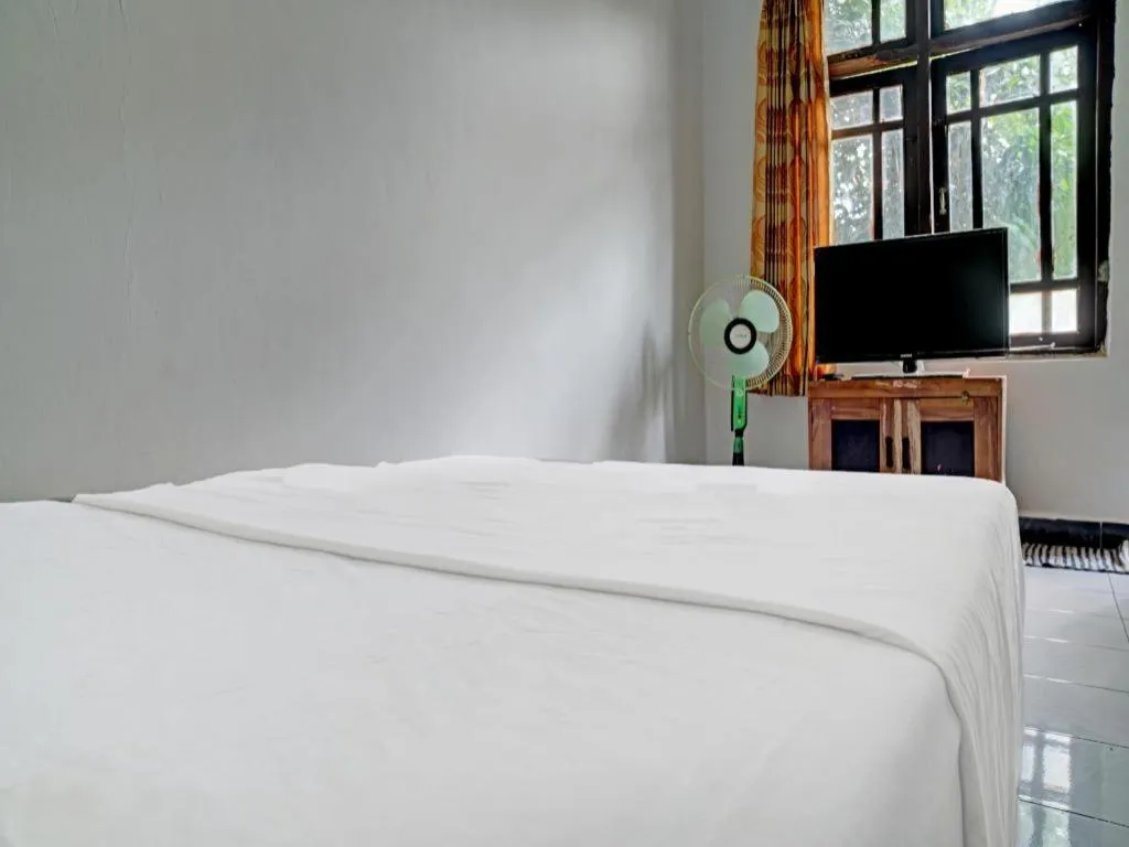 Bed in Hotel O Home Stay Syariah Aom Kusman
