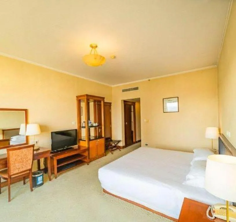 Bed in New Century Hotel Ninghai