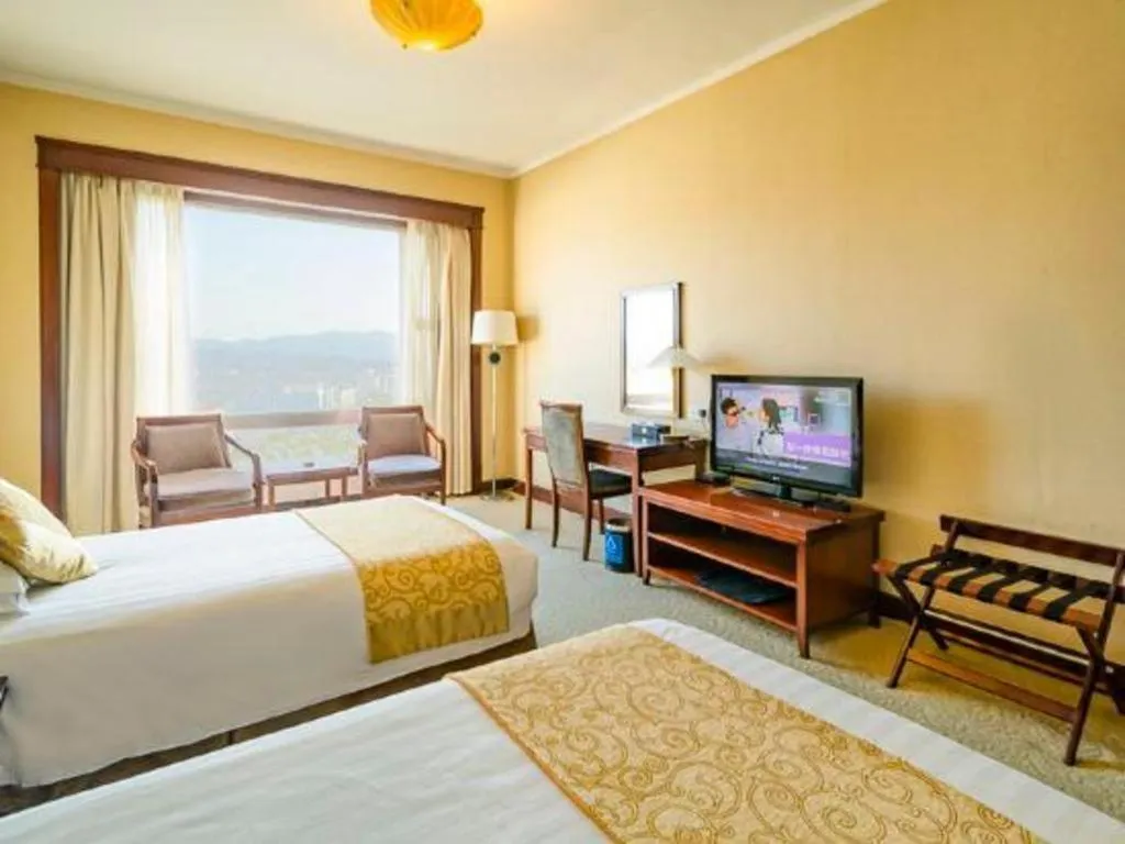 Bed in New Century Hotel Ninghai