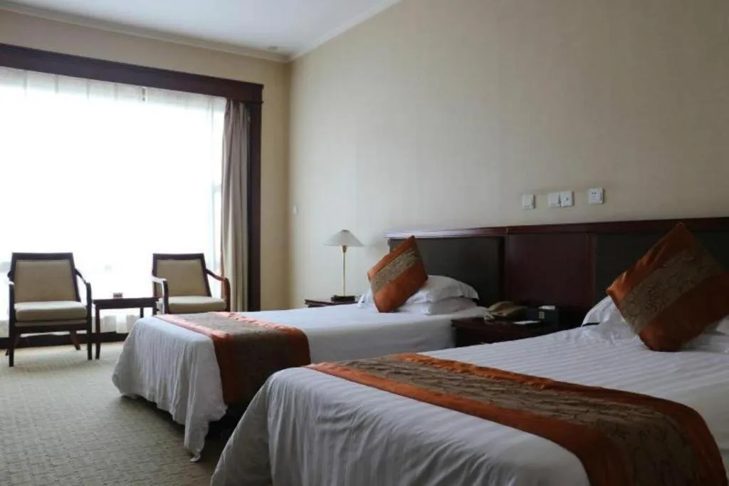 Bed in New Century Hotel Ninghai