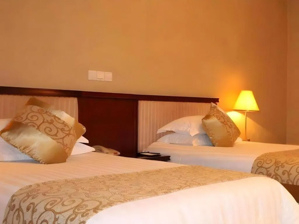 Bed in New Century Hotel Ninghai