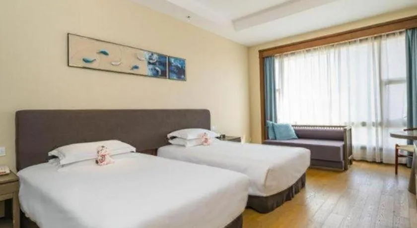 Bed in New Century Hotel Ninghai