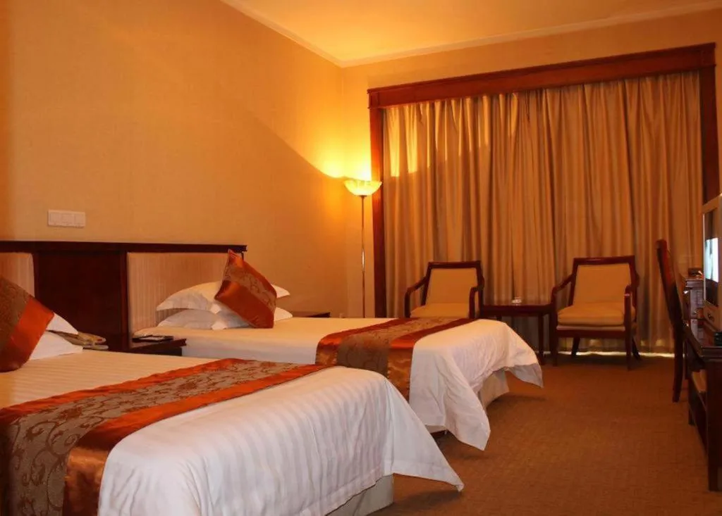 Bed in New Century Hotel Ninghai