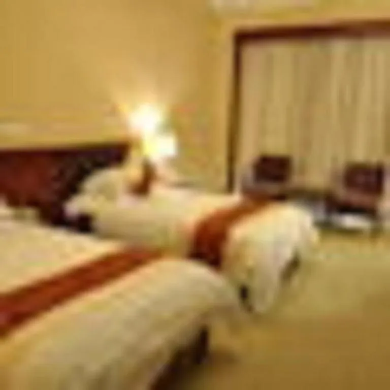 Bed in New Century Hotel Ninghai