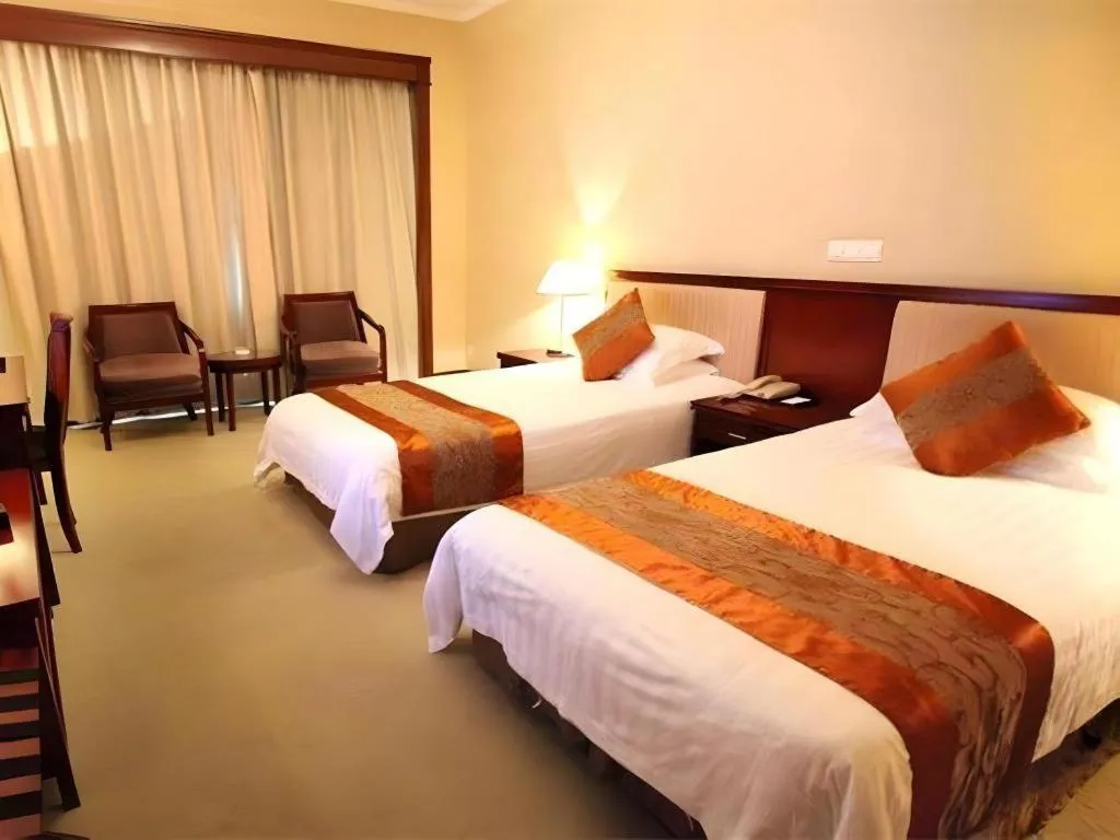 Bed in New Century Hotel Ninghai