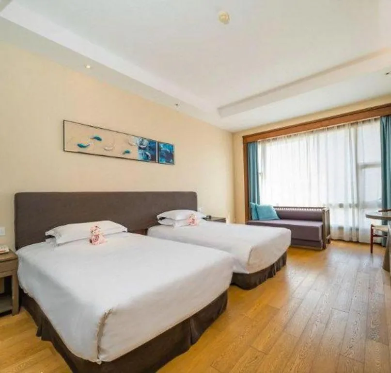 Bed in New Century Hotel Ninghai