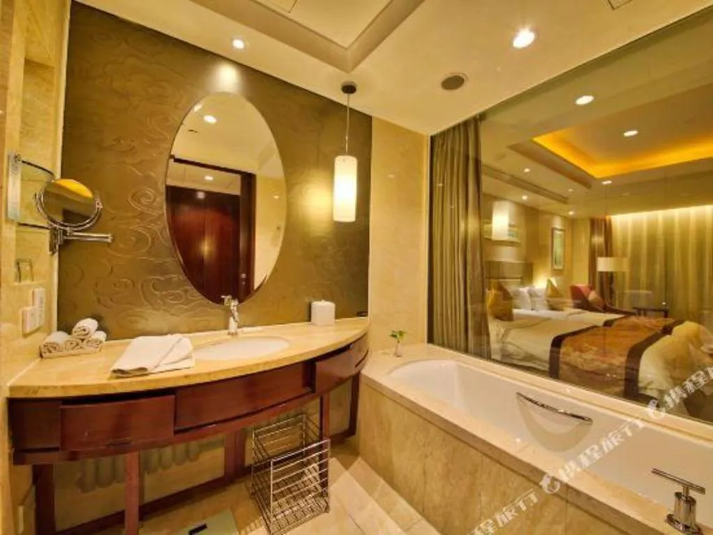 Bed in New Century Grand Changchun Hotel