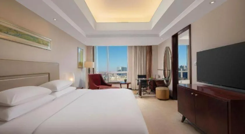 Bed in New Century Grand Changchun Hotel