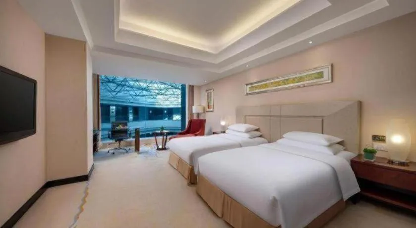 Bed in New Century Grand Changchun Hotel