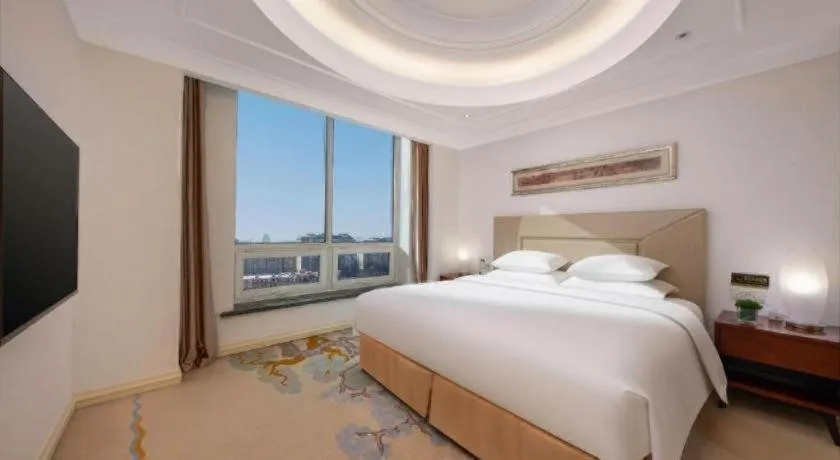 Bed in New Century Grand Changchun Hotel
