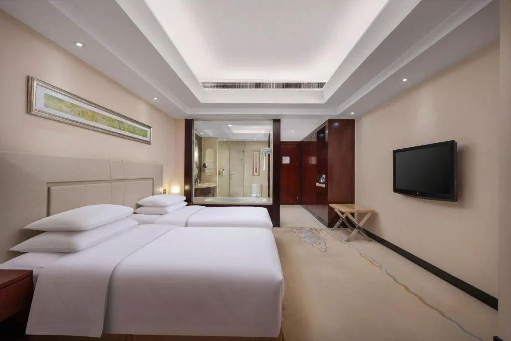 Bed in New Century Grand Changchun Hotel