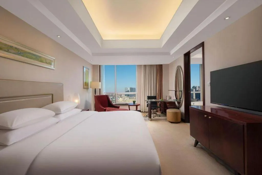 Bed in New Century Grand Changchun Hotel