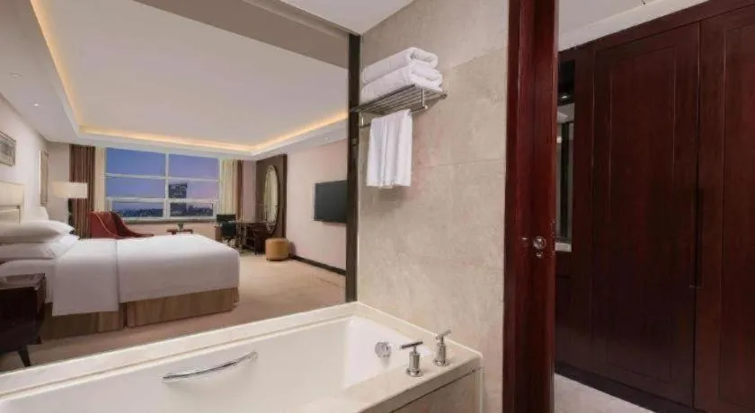 Bed in New Century Grand Changchun Hotel