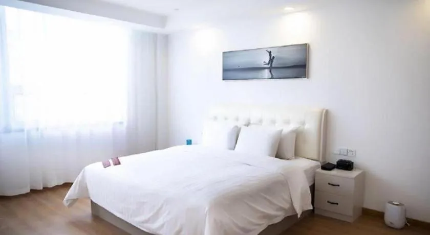 Bed in New Century Grand Changchun Hotel