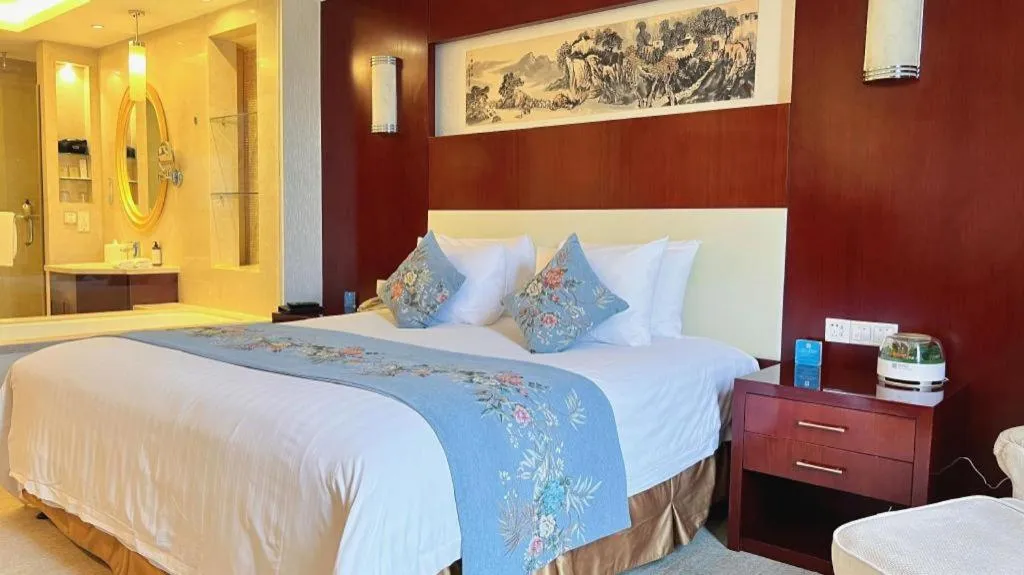 Bed in New Century Hotel Zaozhuang Fengming