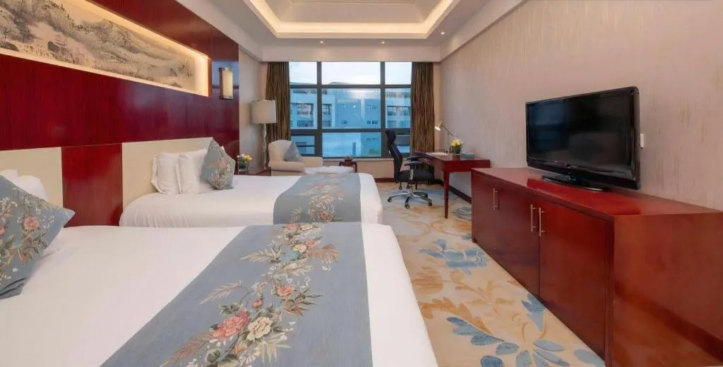 Bed in New Century Hotel Zaozhuang Fengming