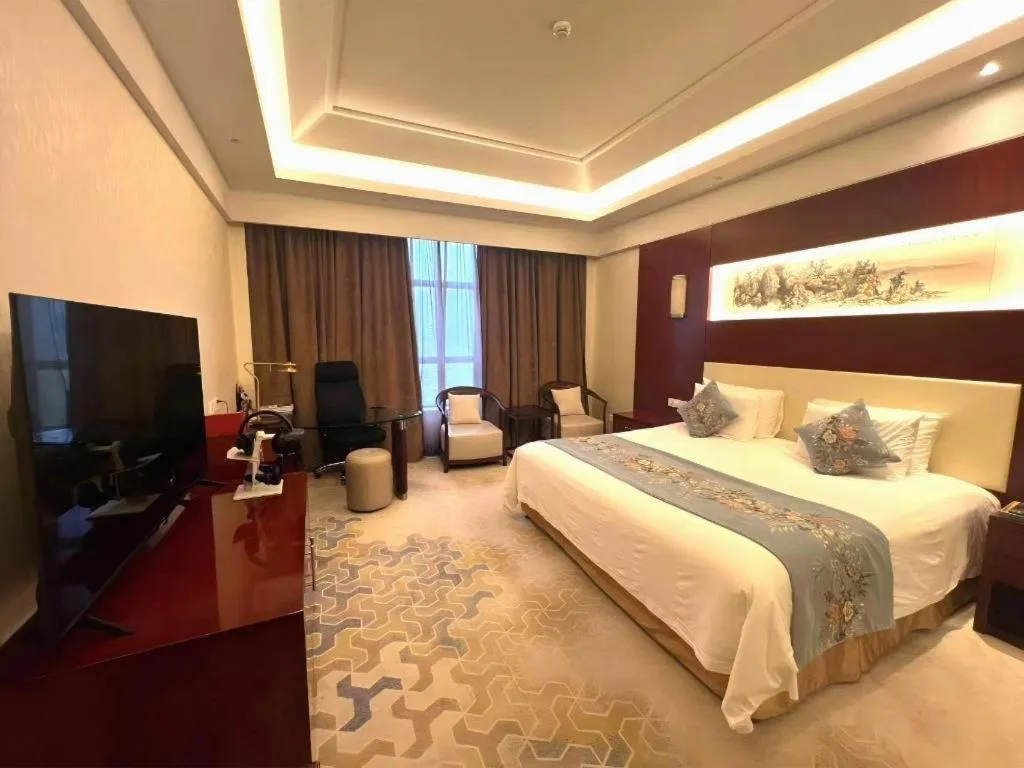 Bed in New Century Hotel Zaozhuang Fengming
