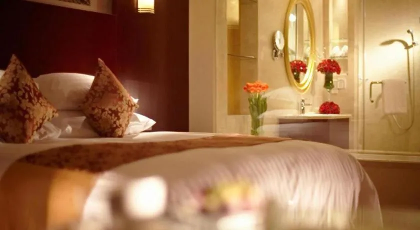 Bed in New Century Hotel Zaozhuang Fengming