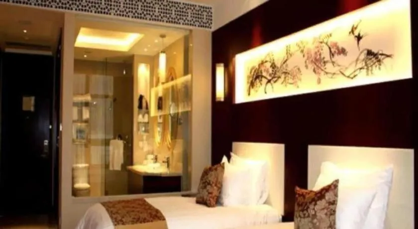 Bed in New Century Hotel Zaozhuang Fengming