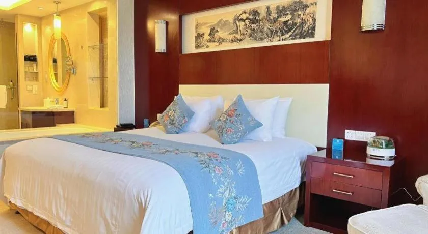 Bed in New Century Hotel Zaozhuang Fengming