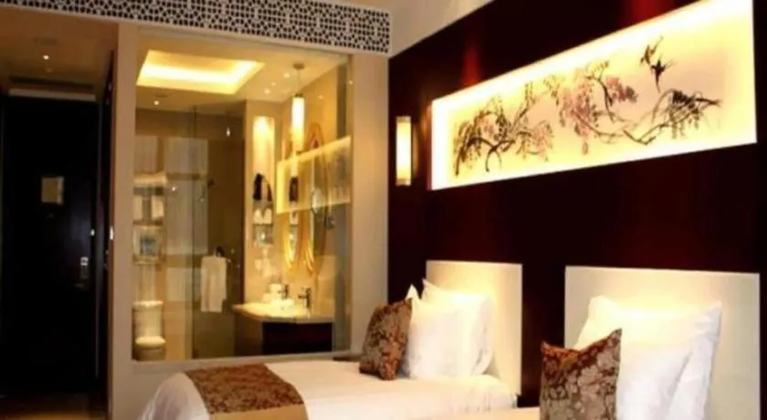 Bed in New Century Hotel Zaozhuang Fengming