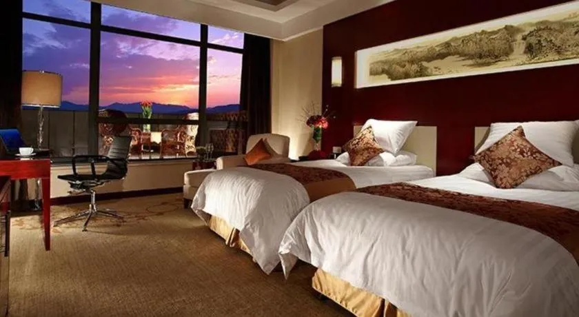 Bed in New Century Hotel Zaozhuang Fengming