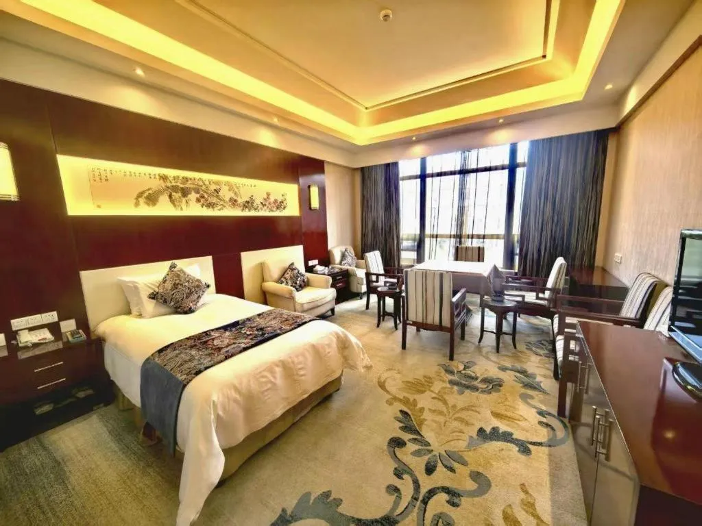 Bed in New Century Hotel Zaozhuang Fengming