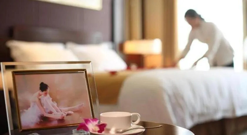 Bed in New Century Hotel Zaozhuang Fengming