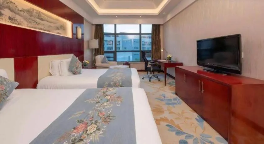 Bed in New Century Hotel Zaozhuang Fengming