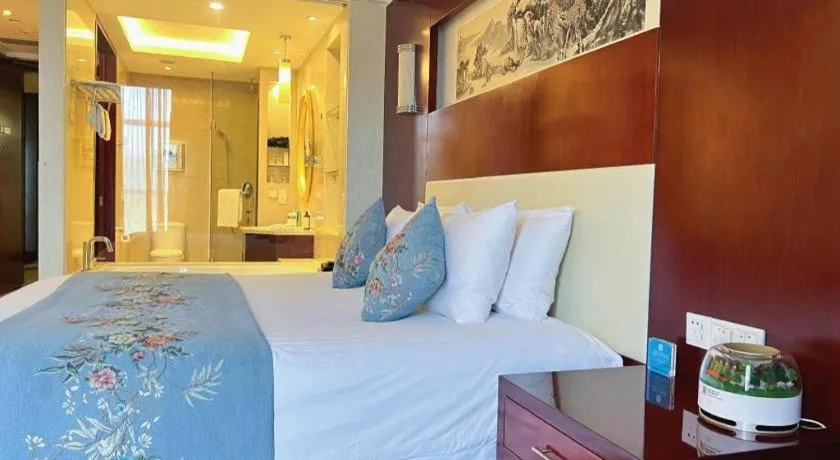 Bed in New Century Hotel Zaozhuang Fengming