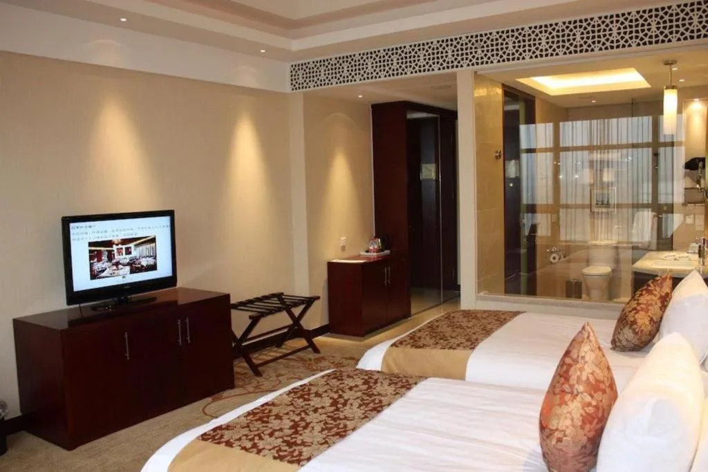 Bed in New Century Hotel Zaozhuang Fengming