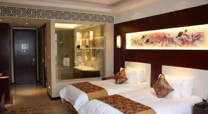 Bed in New Century Hotel Zaozhuang Fengming