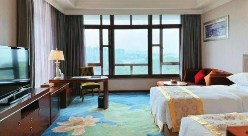 Bed in Xinjin Celebrity City Hotel