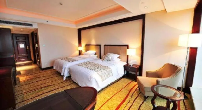Bed in New Century Grand Hotel Zhejiang Sanli