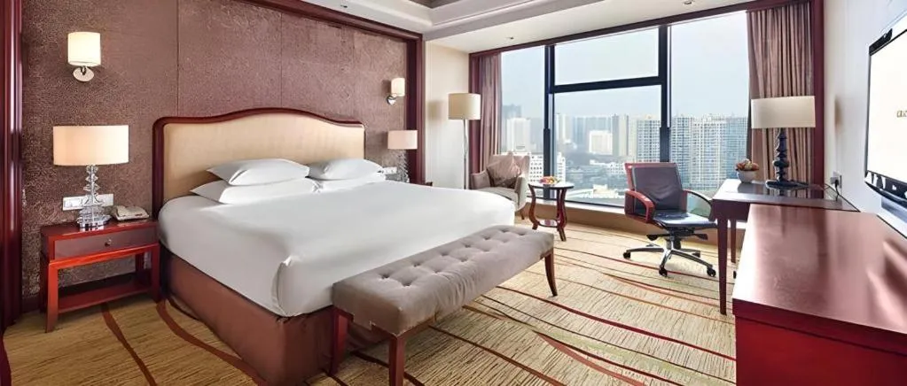 Bed in New Century Grand Hotel Zhejiang Sanli