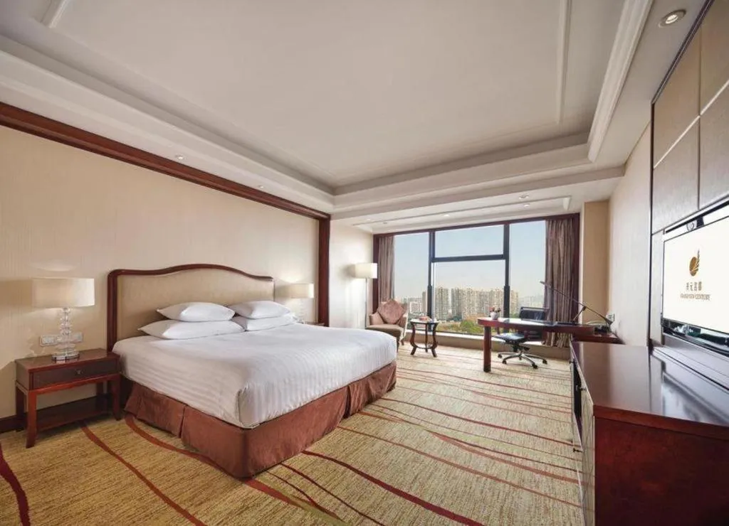 Bed in New Century Grand Hotel Zhejiang Sanli