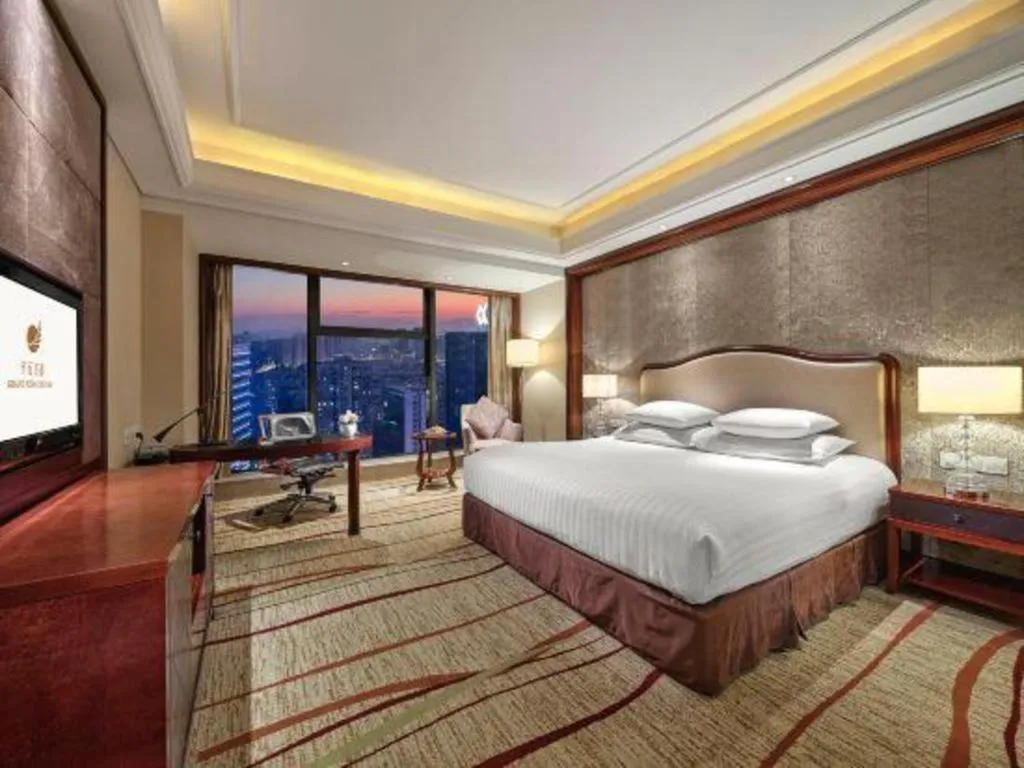 Bed in New Century Grand Hotel Zhejiang Sanli