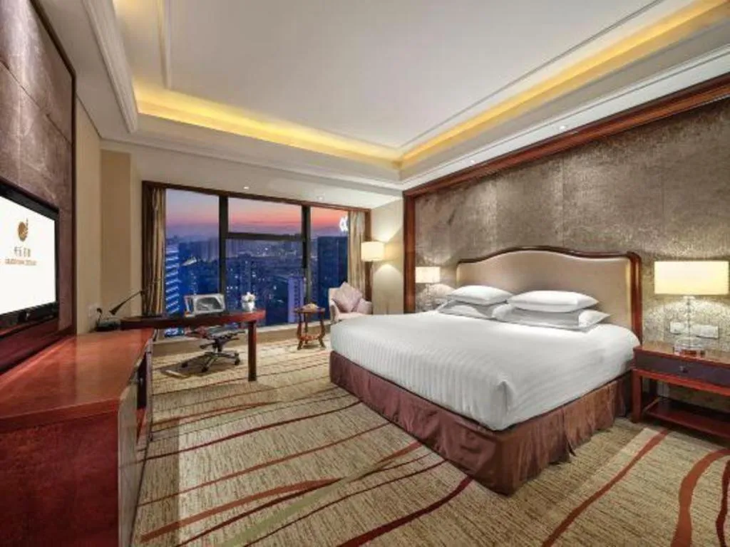Bed in New Century Grand Hotel Zhejiang Sanli