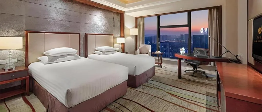 Bed in New Century Grand Hotel Zhejiang Sanli