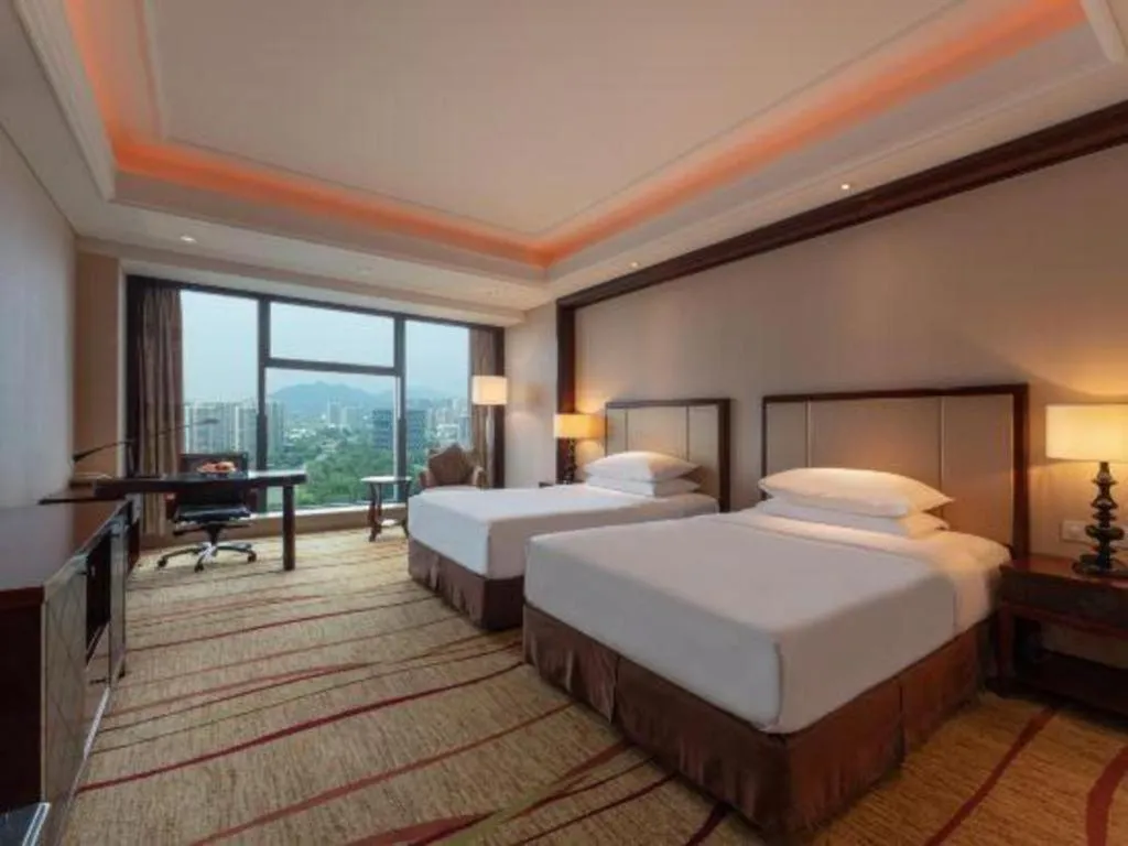 Bed in New Century Grand Hotel Zhejiang Sanli