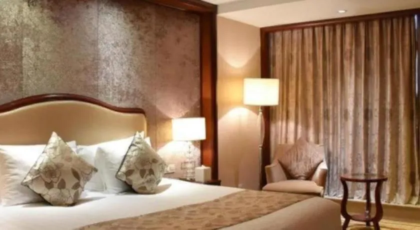 Bed in New Century Grand Hotel Zhejiang Sanli