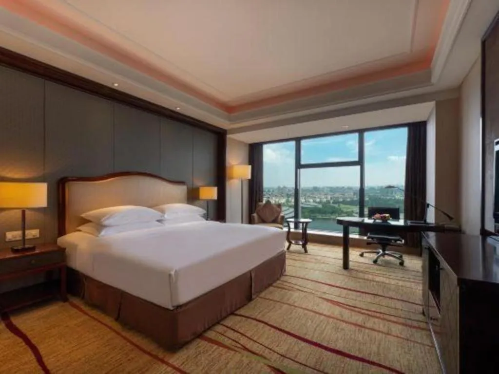 Bed in New Century Grand Hotel Zhejiang Sanli
