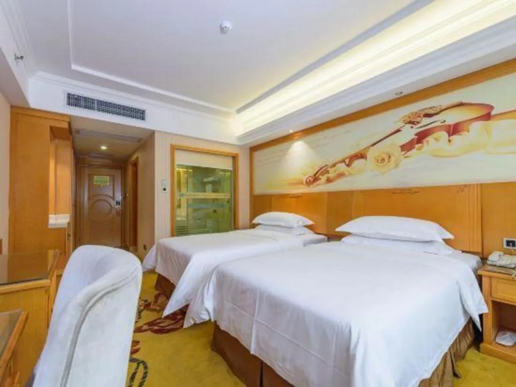 Bed in Vienna Hotel Guangxi Liuzhou Xijiang Vientiane City