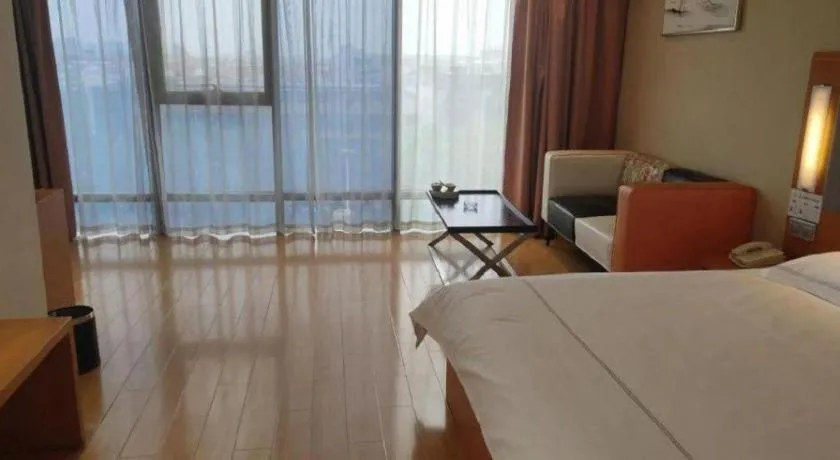 Bed in Warmly Hotel Suzhou Shuanghuwan